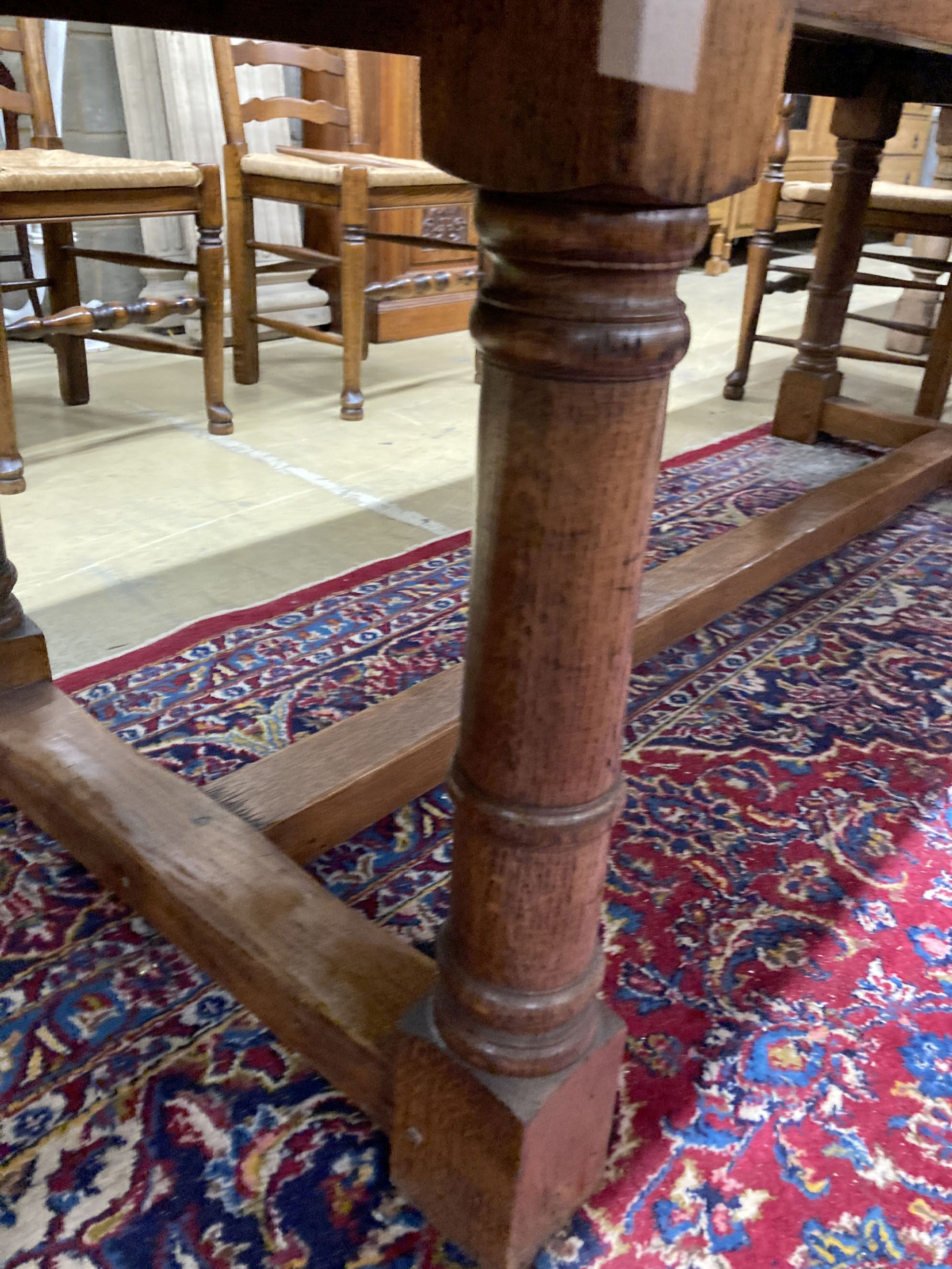 An 18th century style oak refectory dining table, length 214cm, depth 81cm, height 76cm